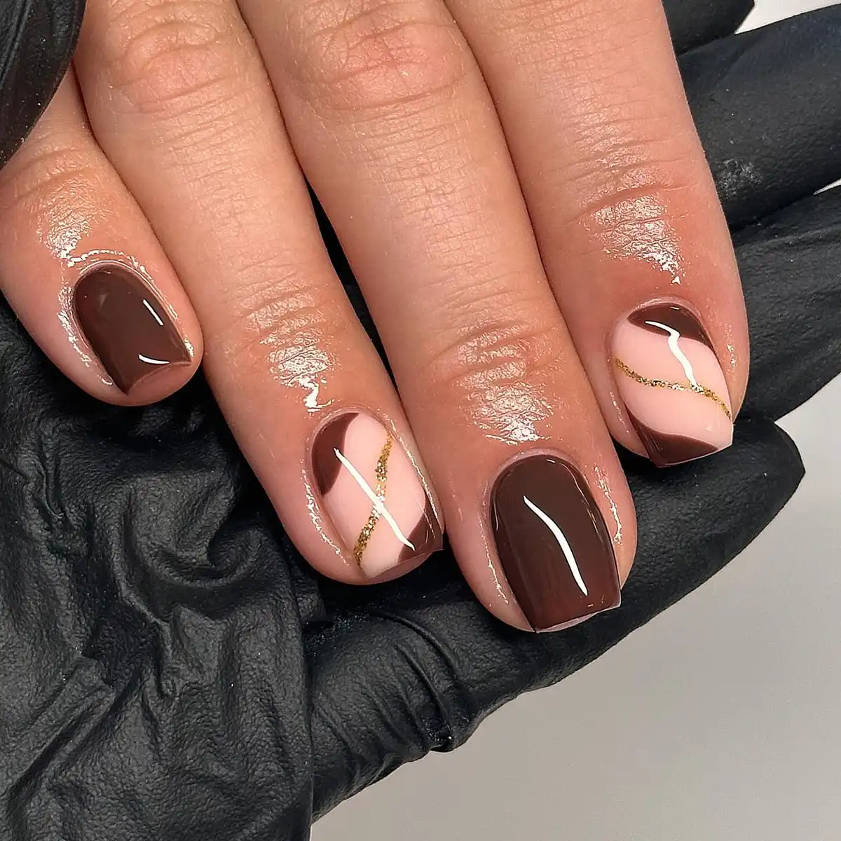 Dark brown solids with nude diagonal design and gold glitter stripe