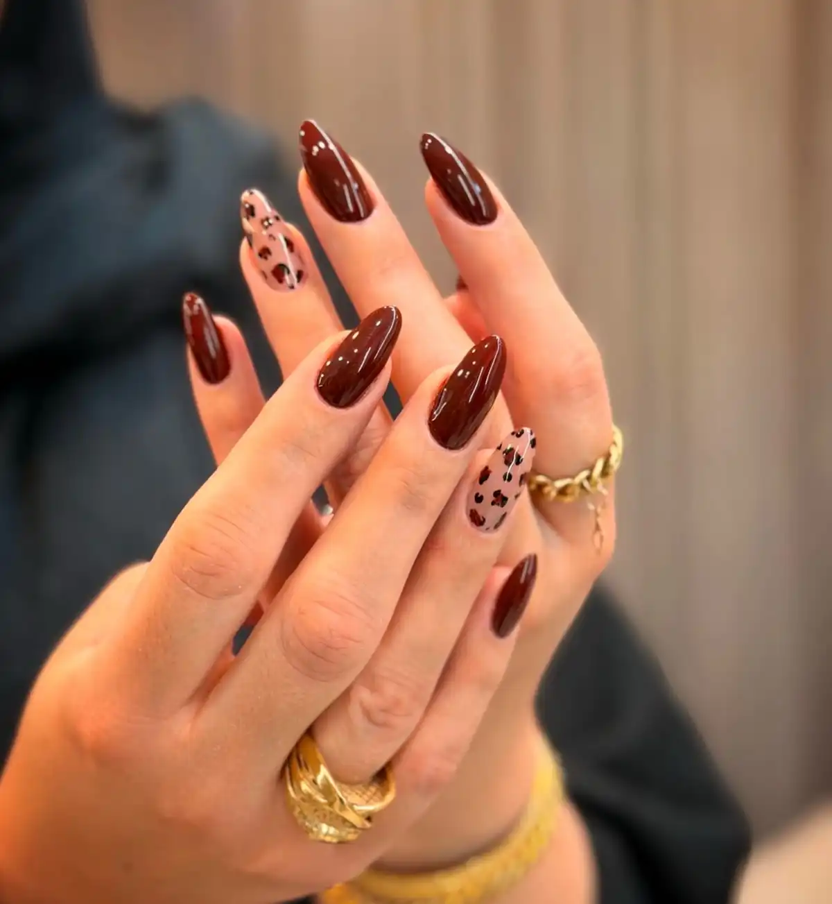 Glossy deep brown with spotted nude accent nails
