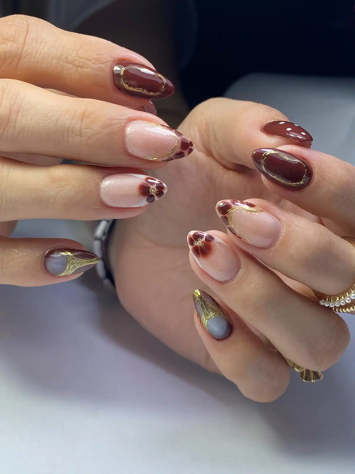 Deep brown and nude mix with gold outlines and spotted tips