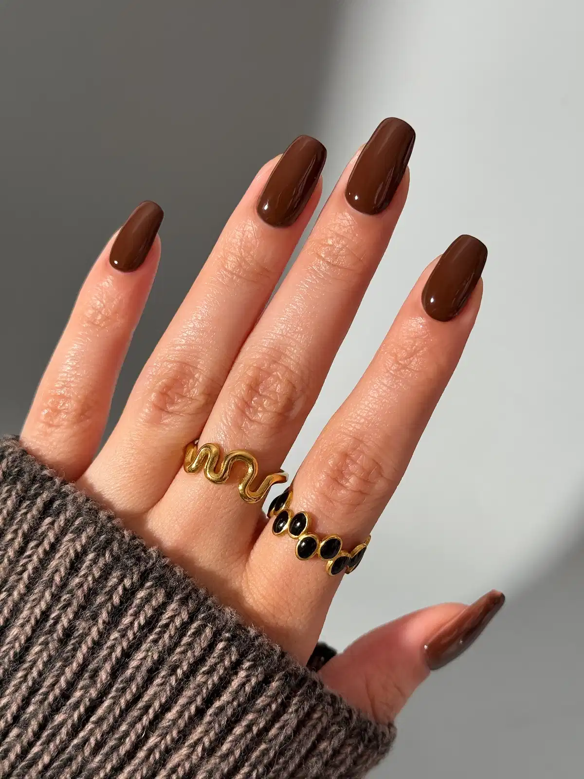 Solid glossy chocolate brown on long square nails