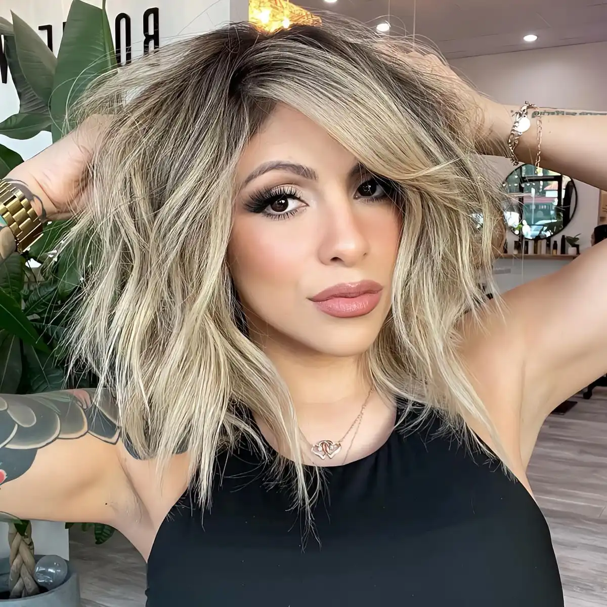 Textured shoulder-length blonde with dark roots