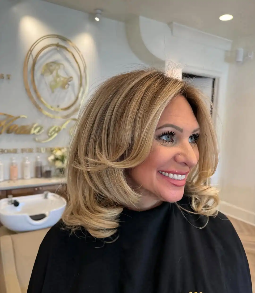 Voluminous warm blonde with curled-under ends
