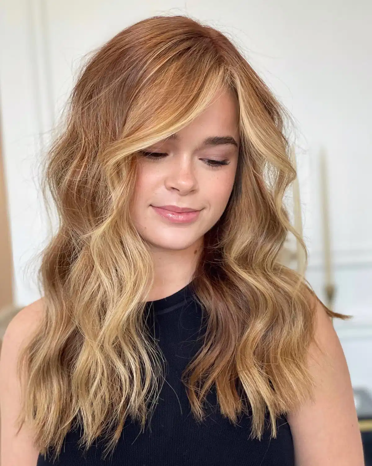 Warm brown-blonde blend with side-swept waves