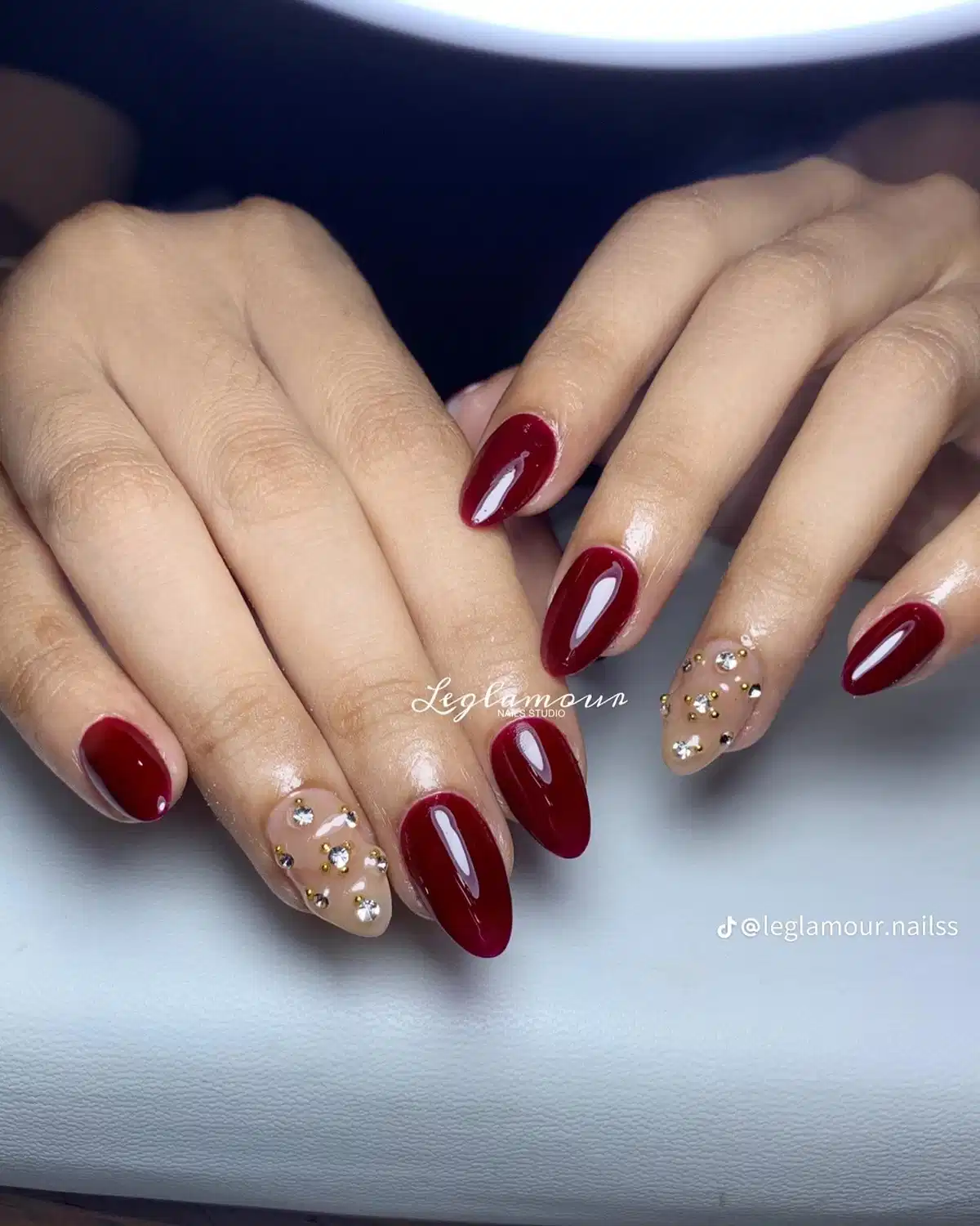 Solid maroon with nude rhinestone accent nails