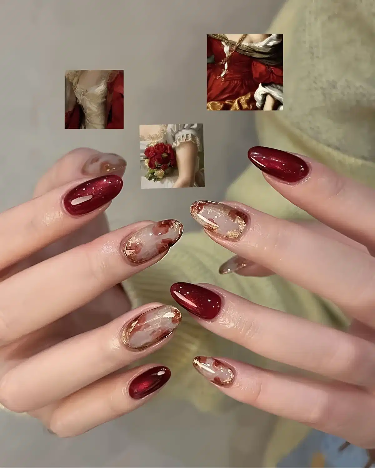 Maroon almond nails with marbled nude-and-gold accents