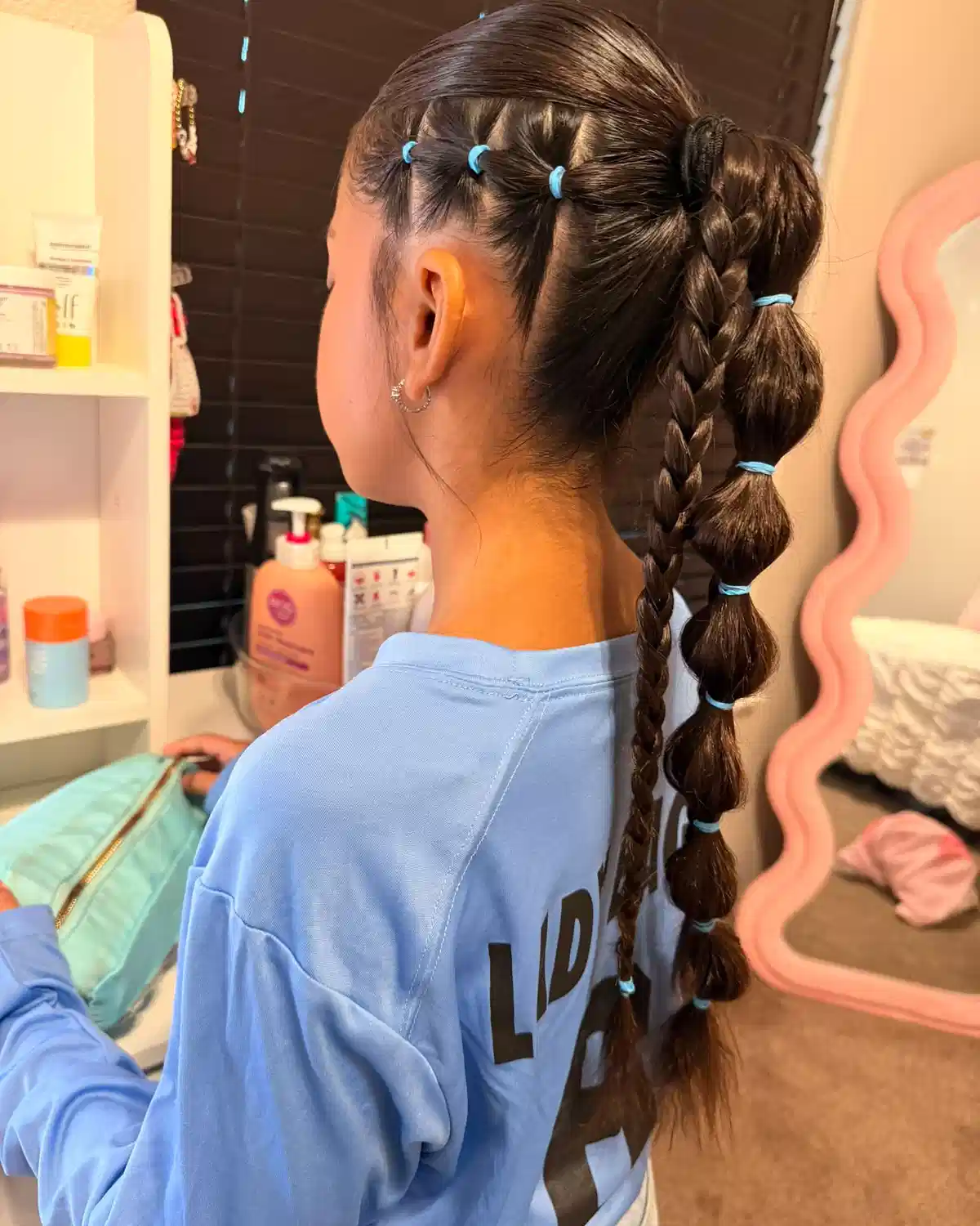 Bubble ponytail with side sectioning and long braid
