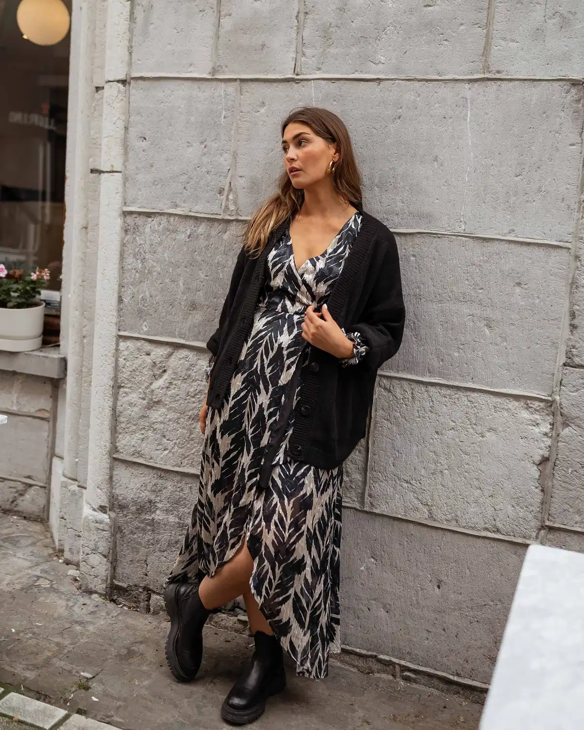 Patterned midi dress with black cardigan and boots