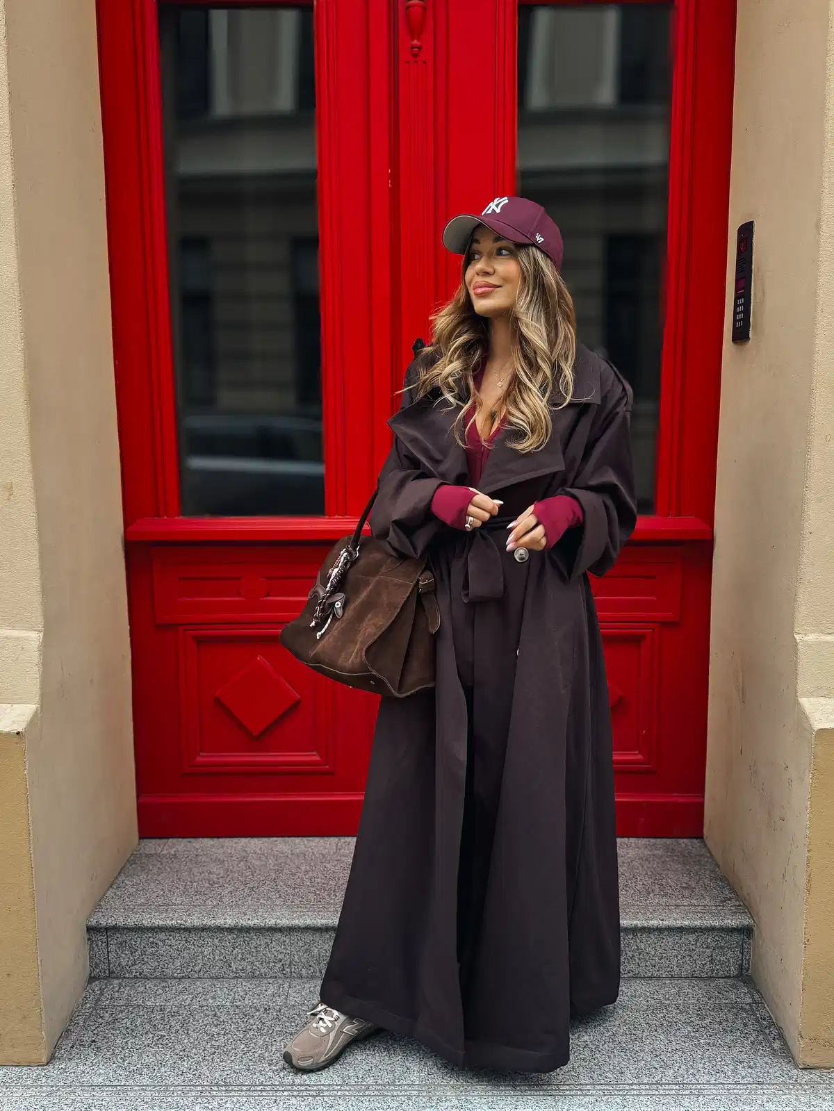 Burgundy cap with long dark belted coat
