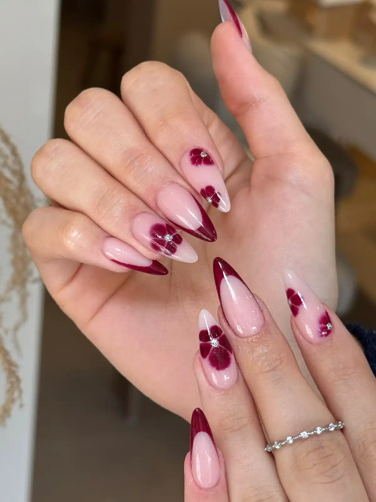 Maroon French Tips with Floral Motifs and Rhinestone Centers