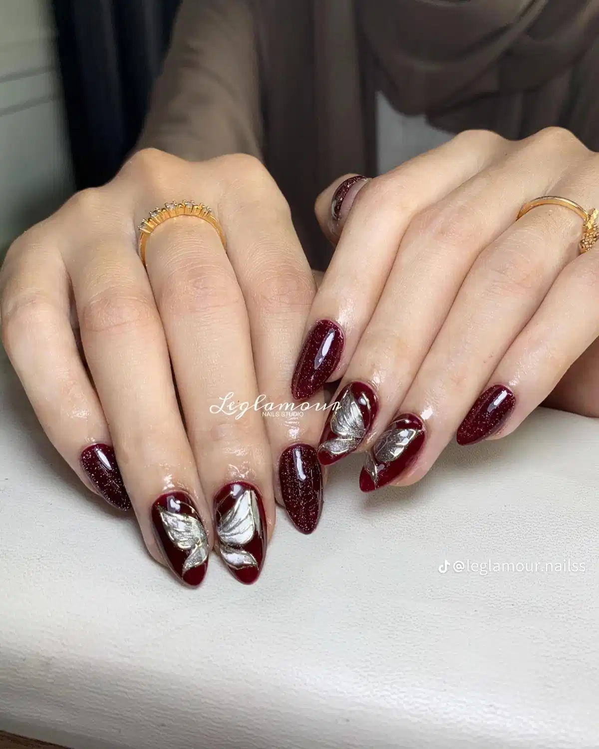 Glittered maroon with bold silver leaf accents