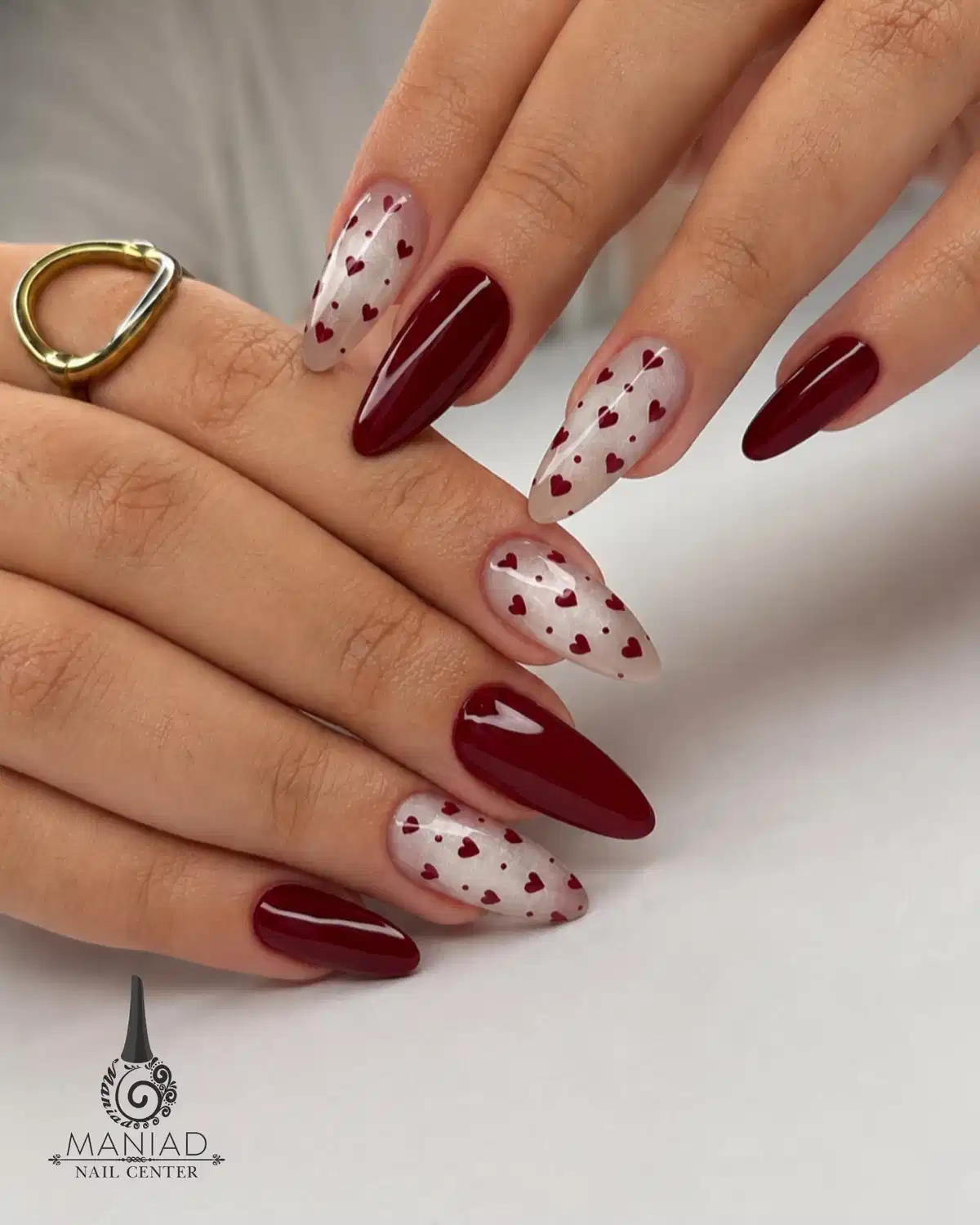 Maroon solids with heart-pattern sheer accent nails