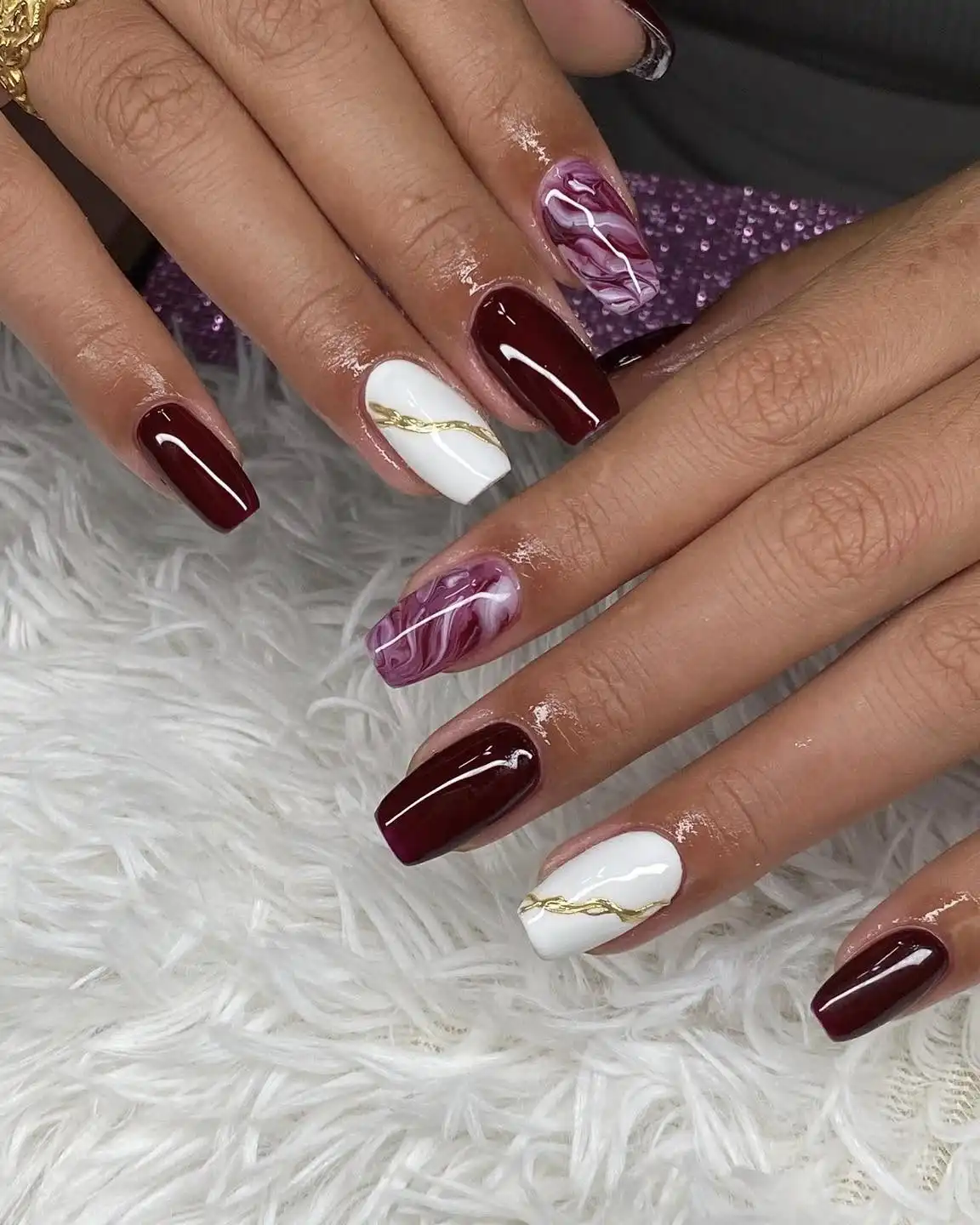Maroon and white mix with gold waves and purple-white swirls