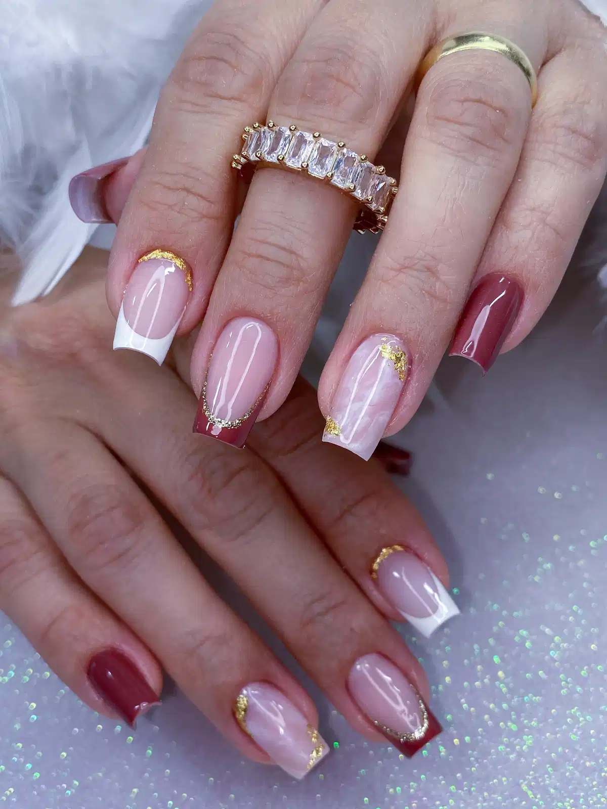 Nude Base with White and Maroon French Tips Plus Gold Accents