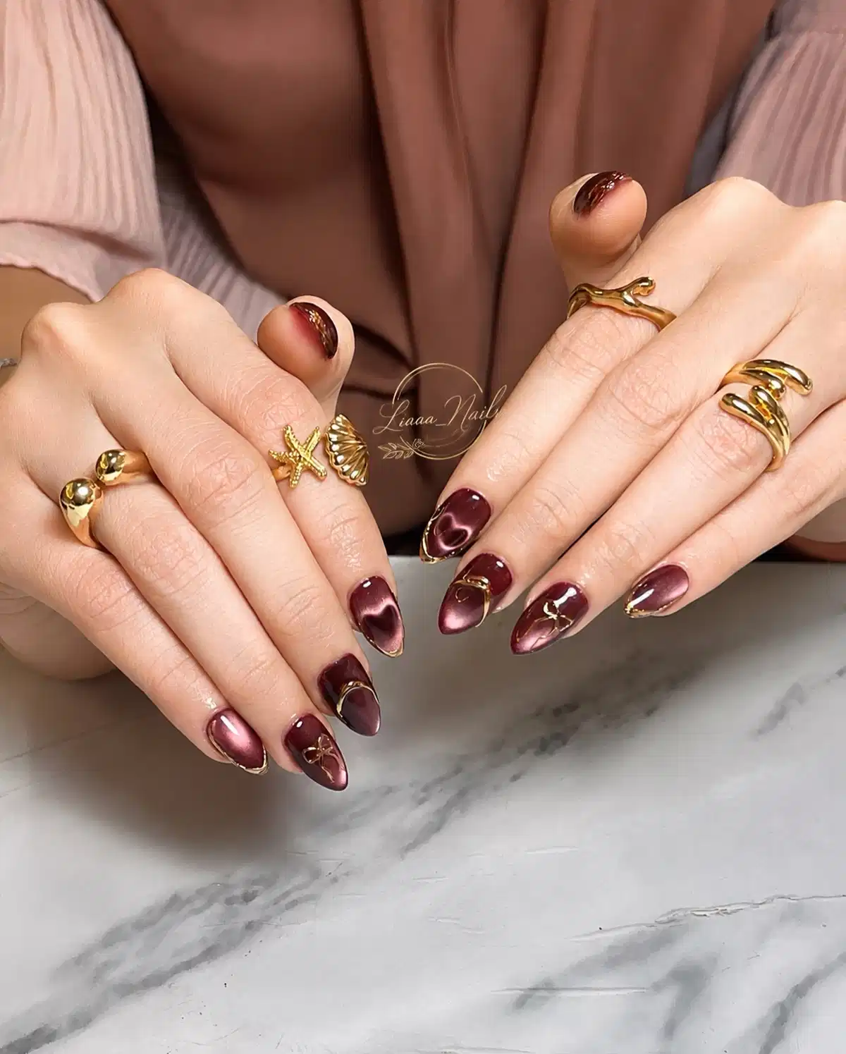 Maroon cat-eye with gold edging and heart detail