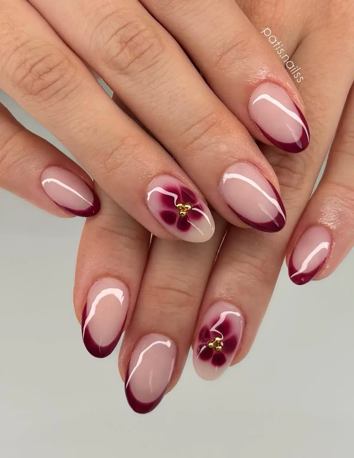 Side-Swept Maroon French Tips with Floral Centers
