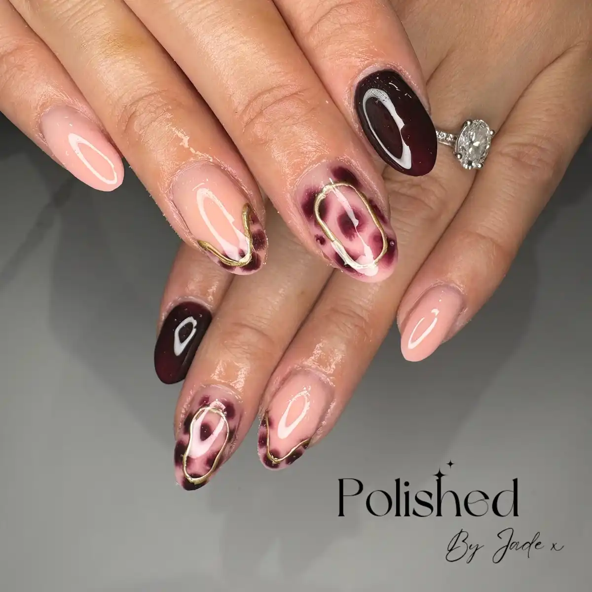 Nude and deep maroon with irregular maroon patches and gold framing