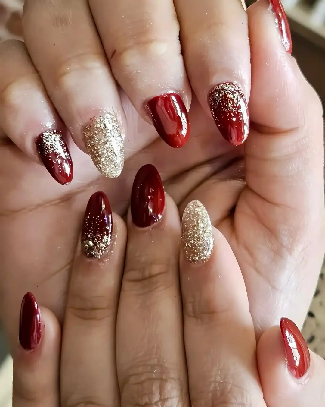 Maroon Almond Nails with Full Gold Glitter Accents