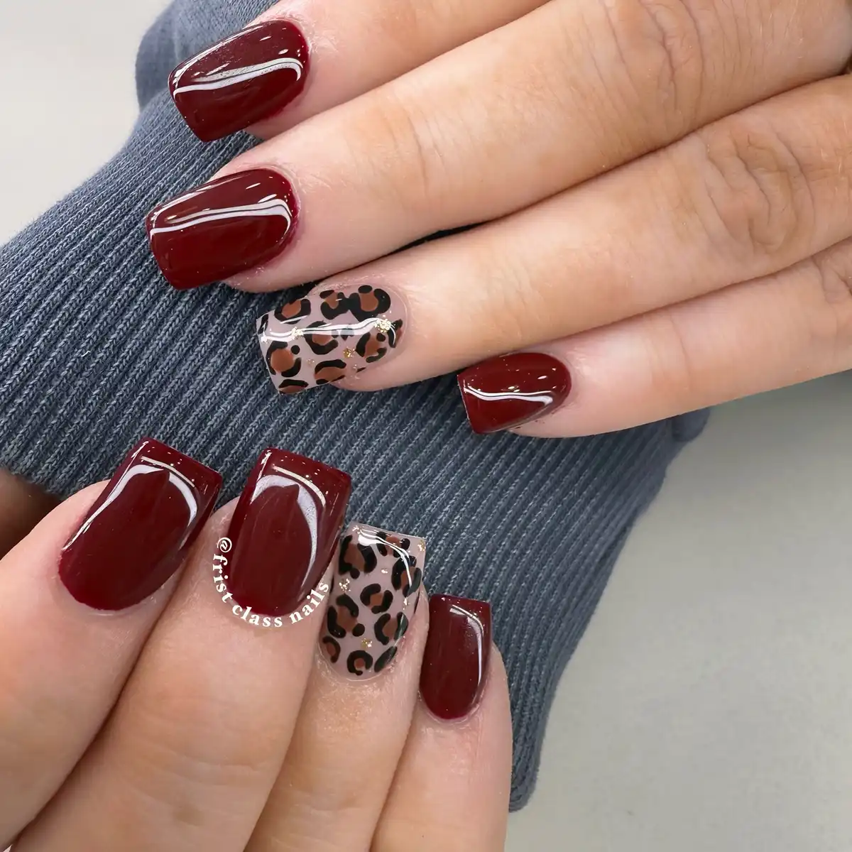 Glossy maroon squares with nude leopard accent nails