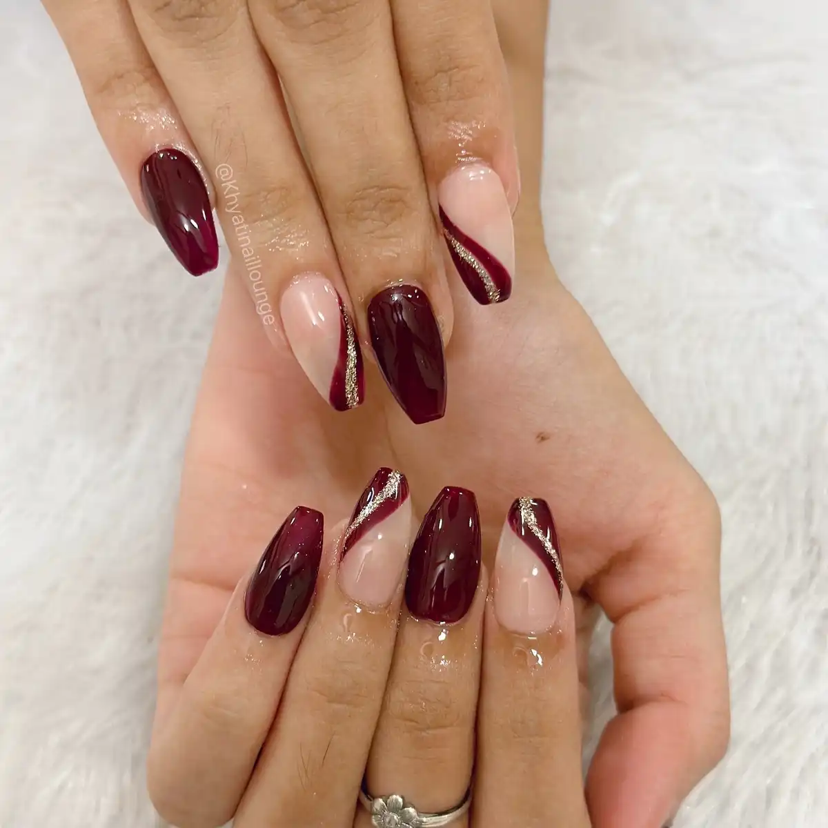 Maroon coffin nails with nude diagonals and gold striping