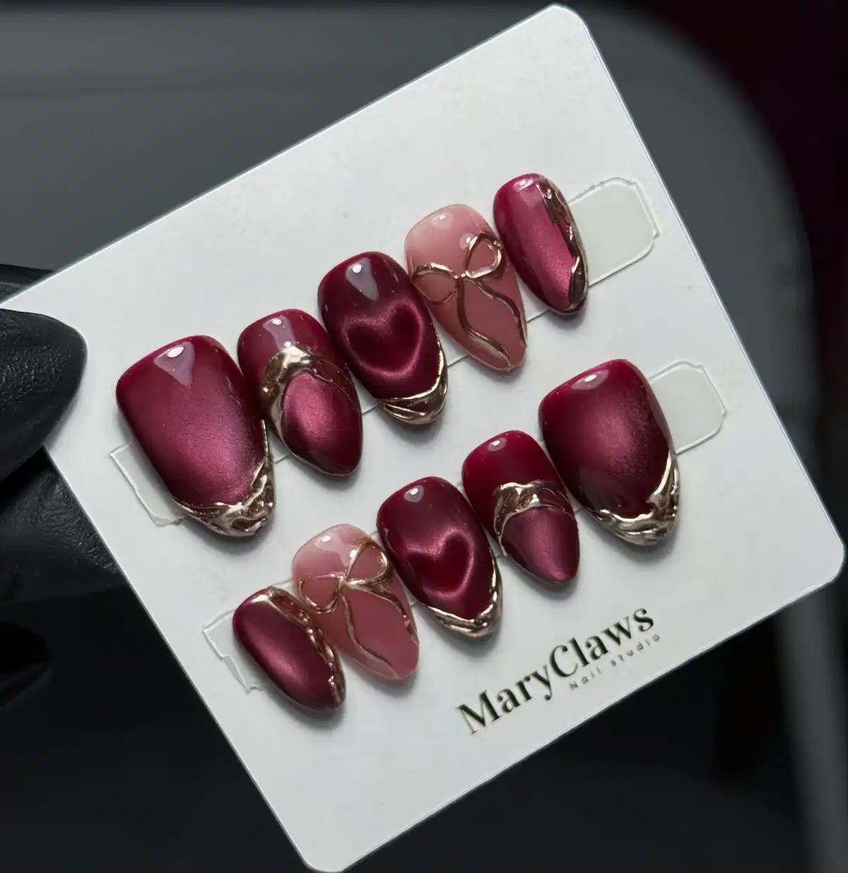 Maroon matte set with gold edging, raised hearts, and bow accents