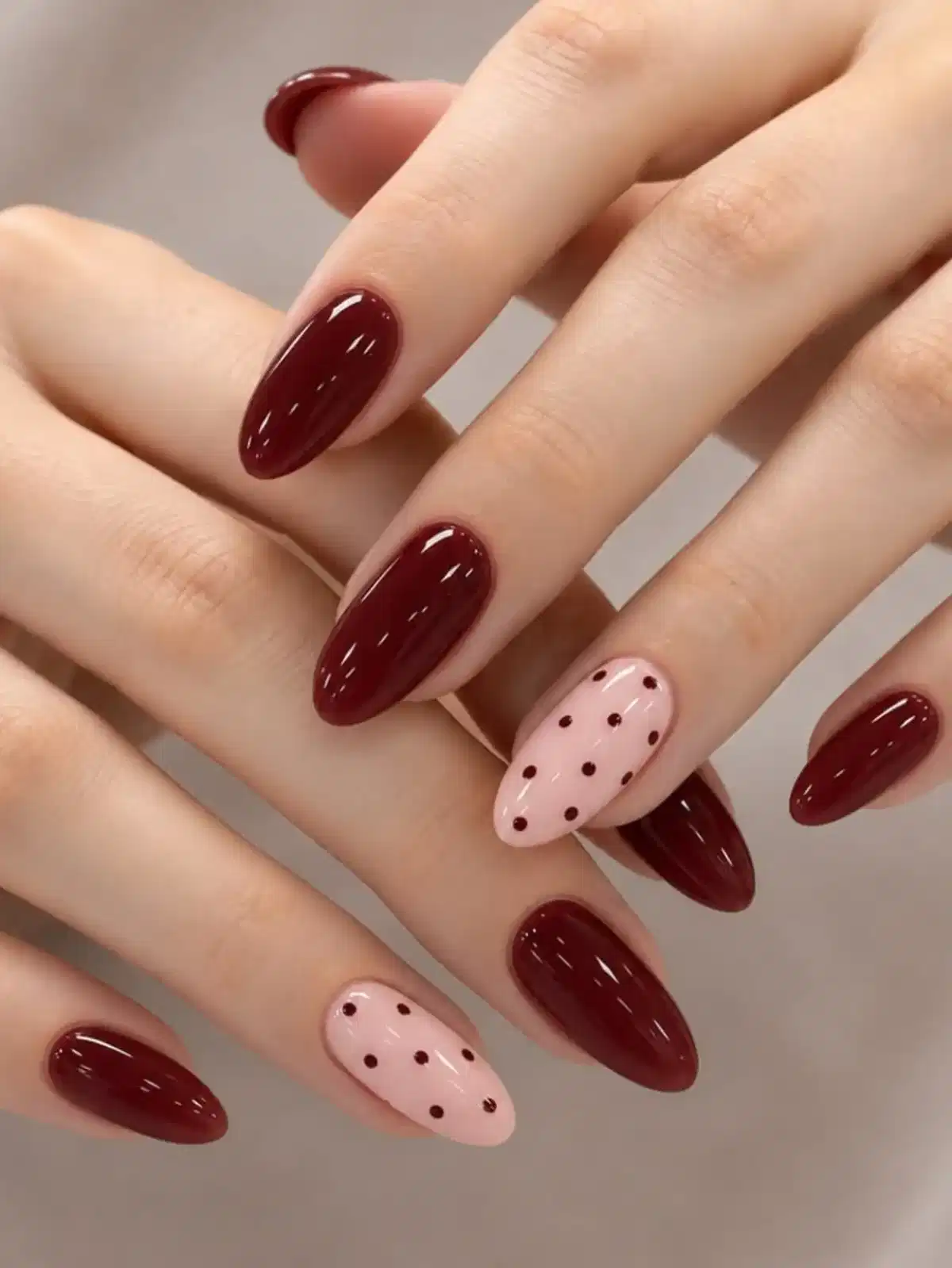 Glossy maroon almonds with pale pink polka-dot accents