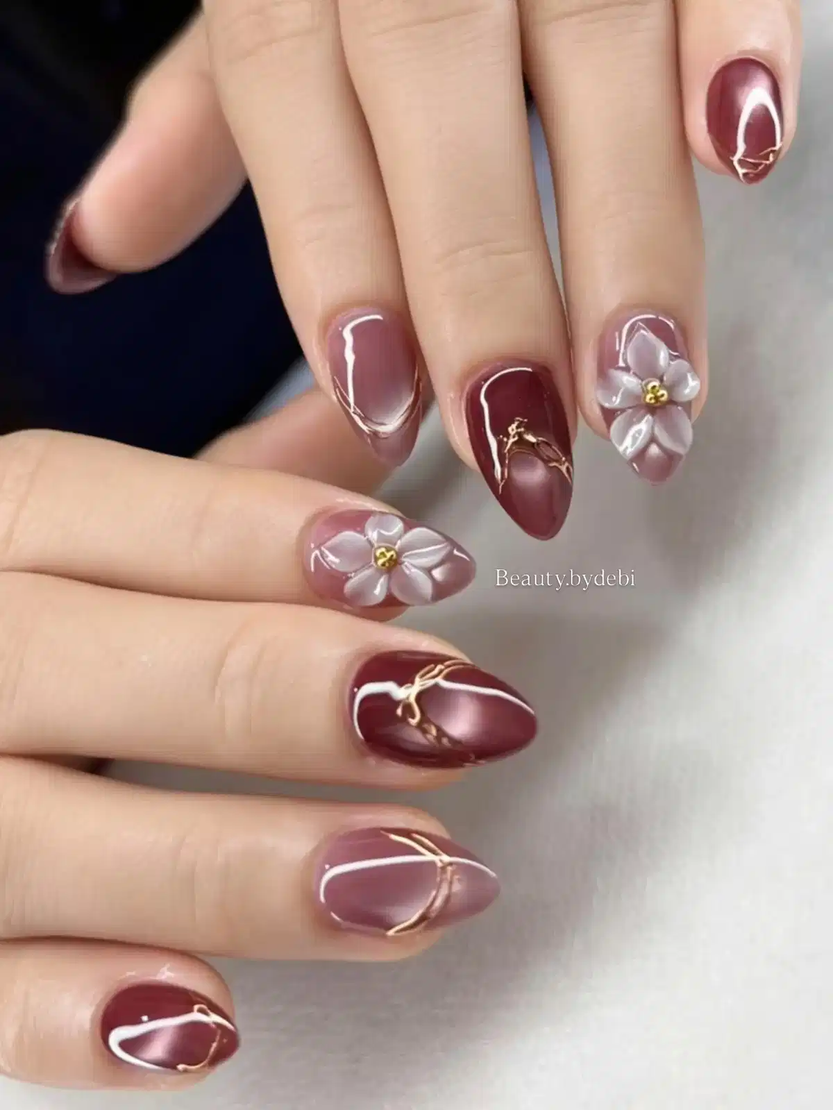 Glossy maroon with gold lines and 3D white flowers