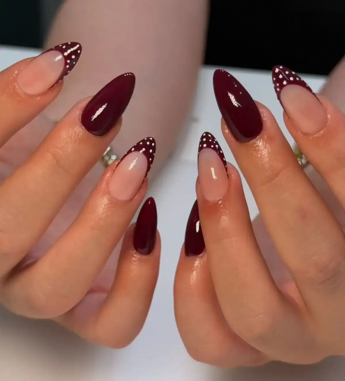Maroon French tips with white polka dots