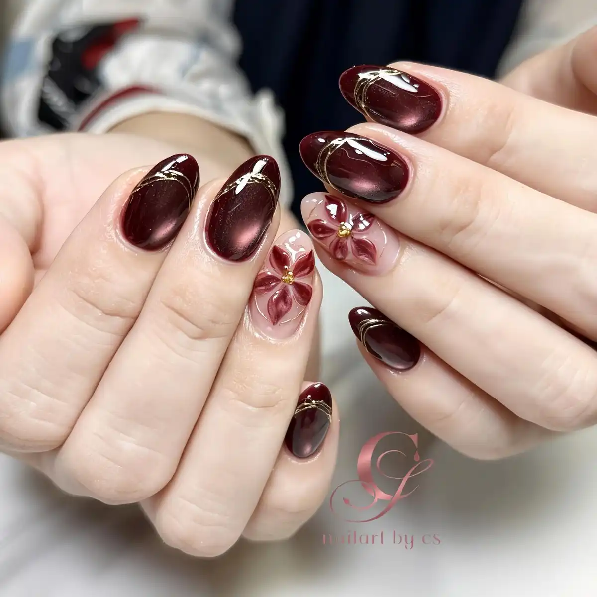 Deep maroon with gold striping and raised floral accents