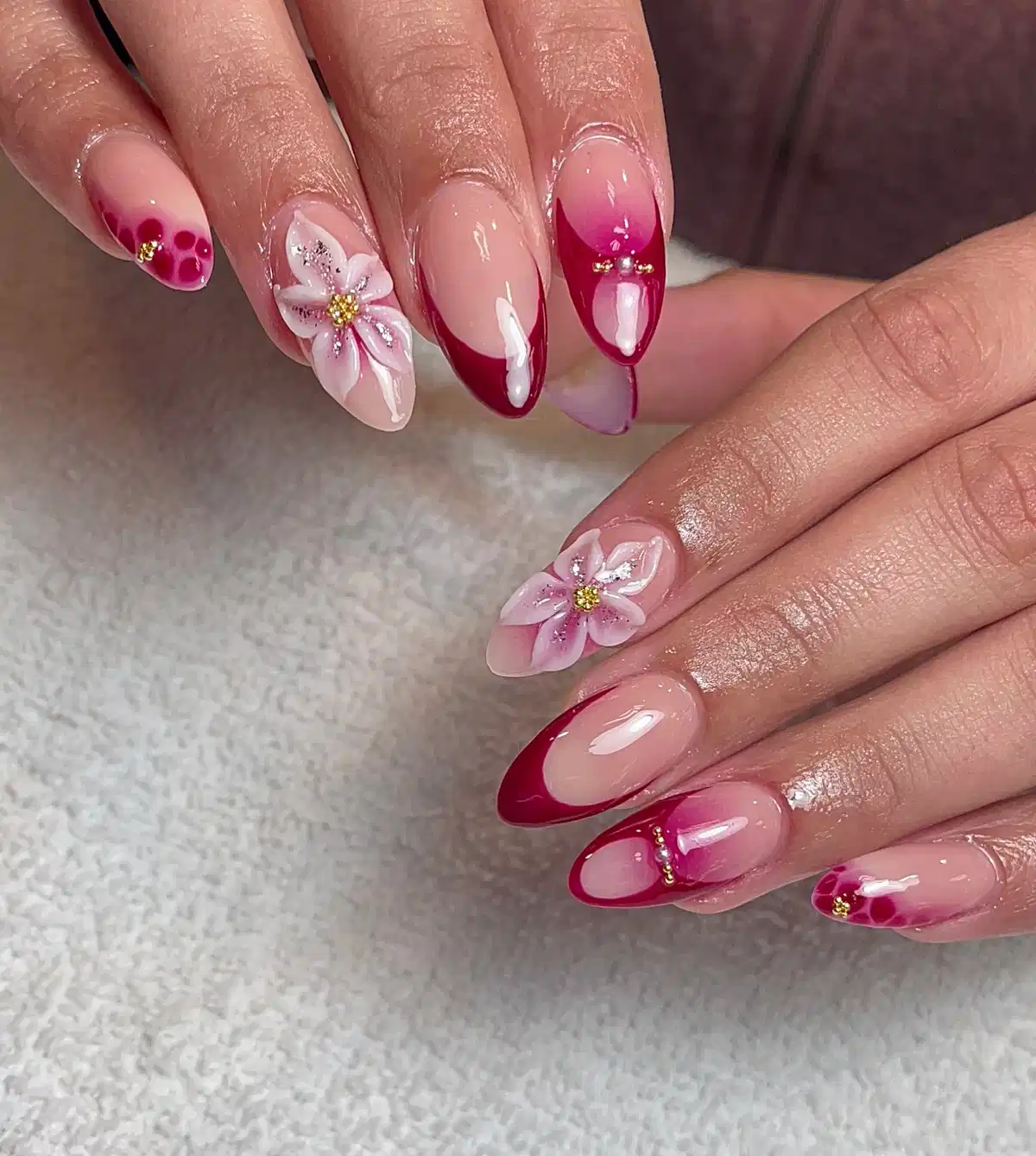 Maroon French tips with gradient accents and raised flowers