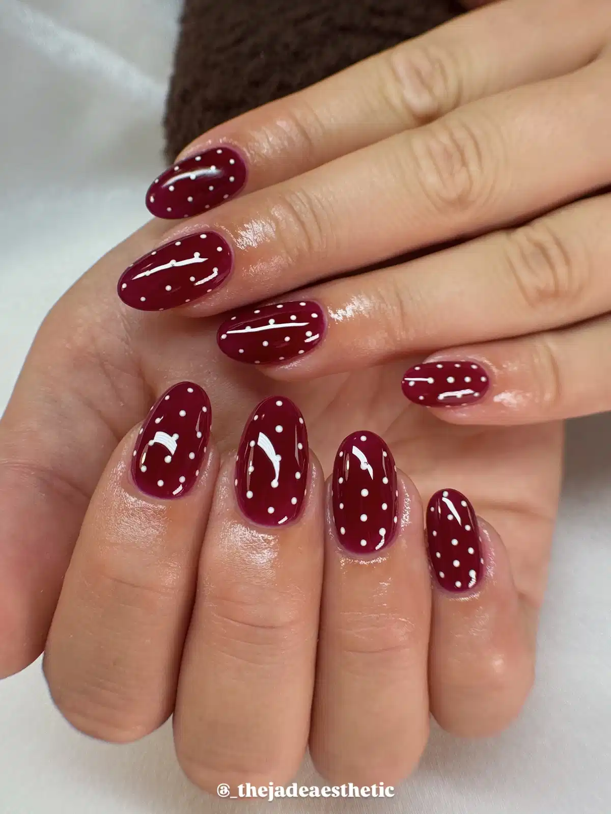 Maroon polka dots with thin white line accents