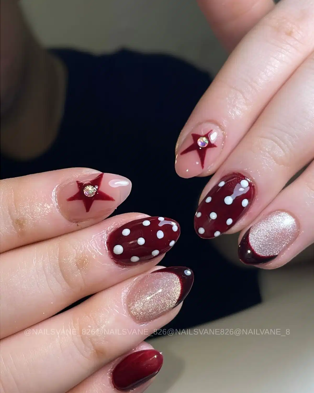 Maroon polka dots with star accents and metallic nail