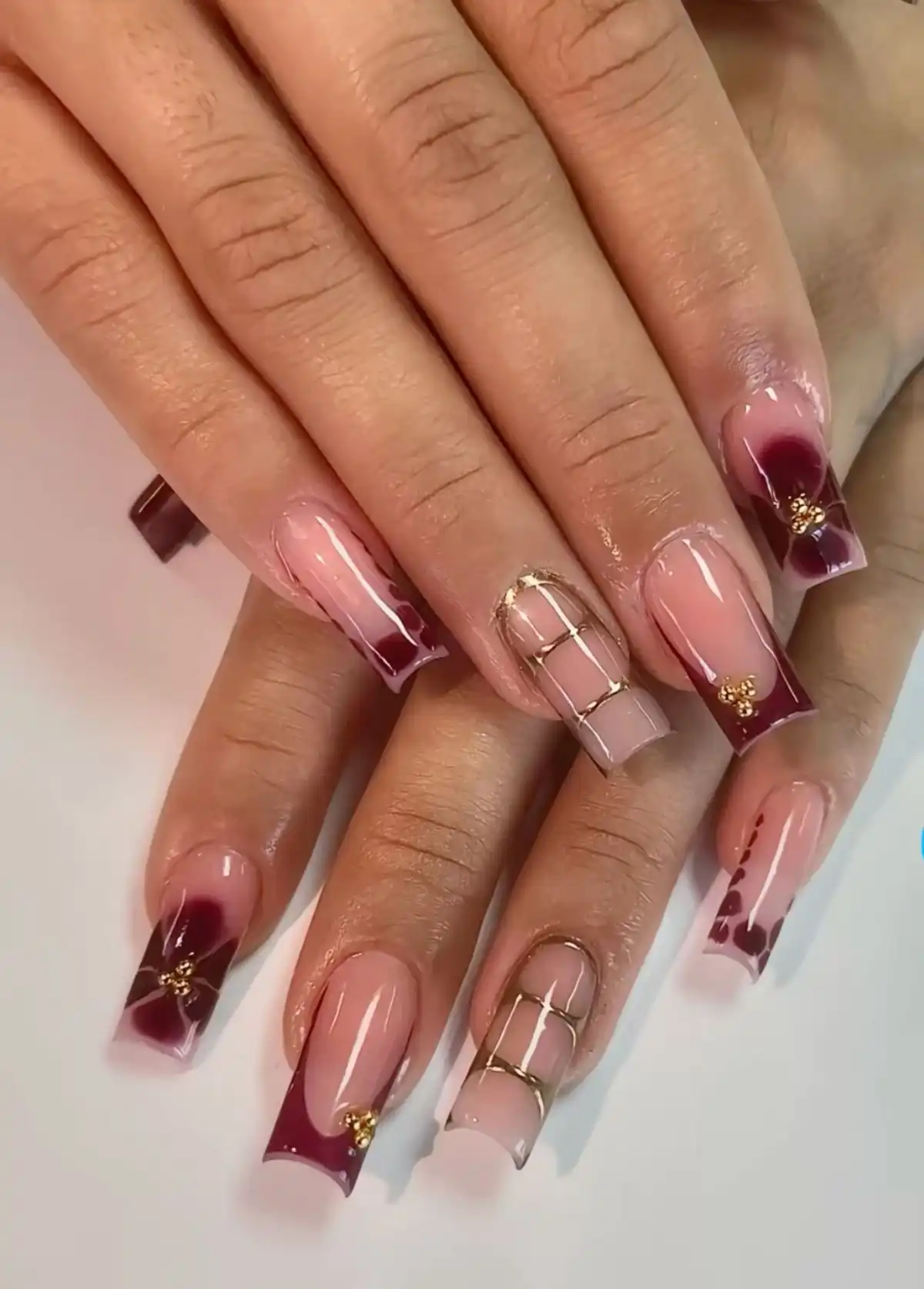 Maroon-and-White Curved Tips with Dots and Floral Accent