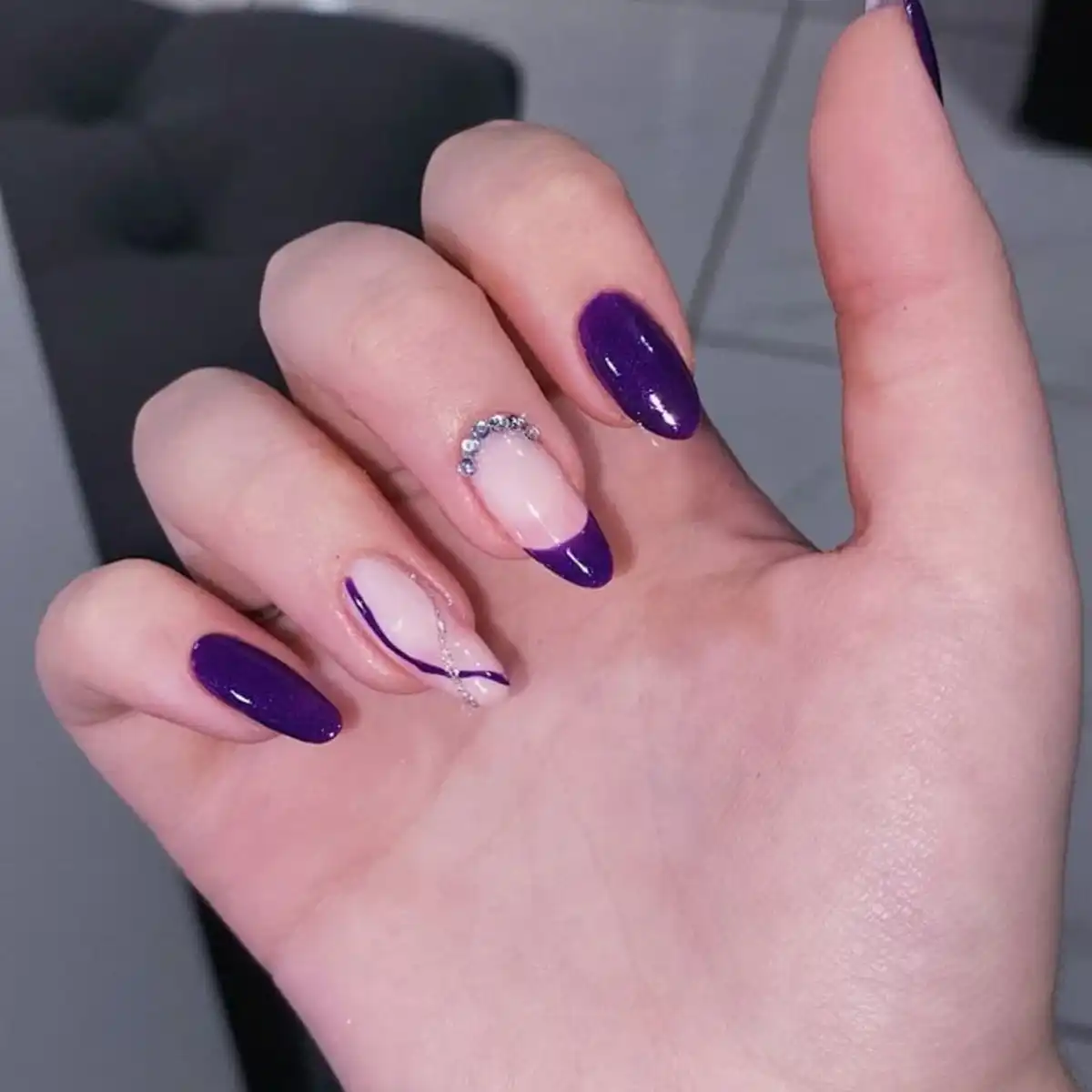 Glossy purple French tips with rhinestone and line accents