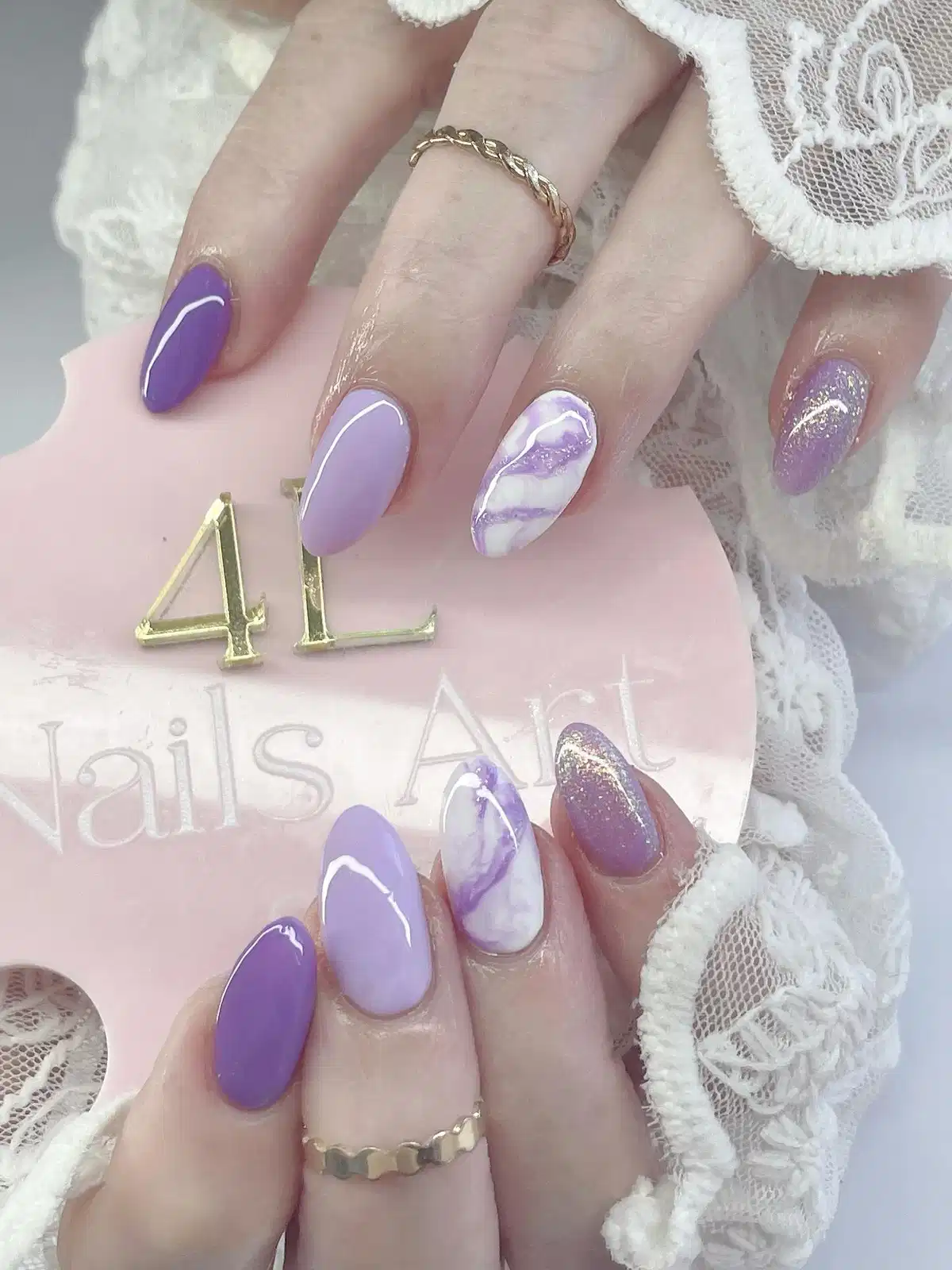 Purple and lilac mix with swirl accents and glitter nails