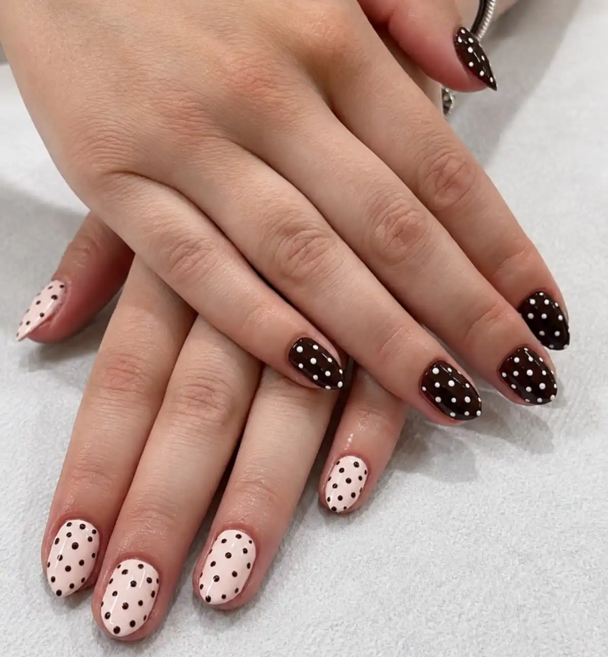 Almond short nails with brown-and-pink polka dots