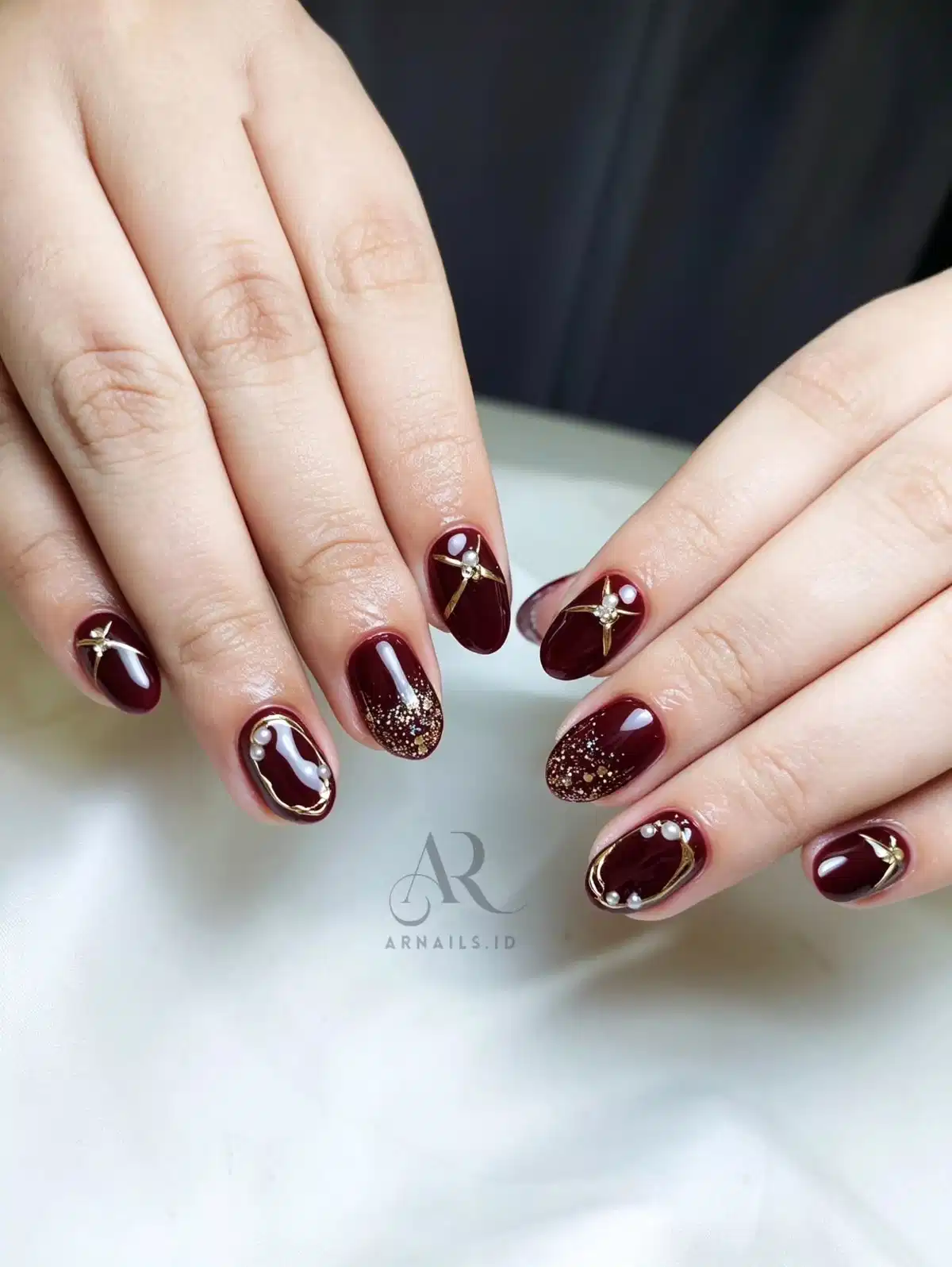 Maroon with framing, beads, and star embellishments