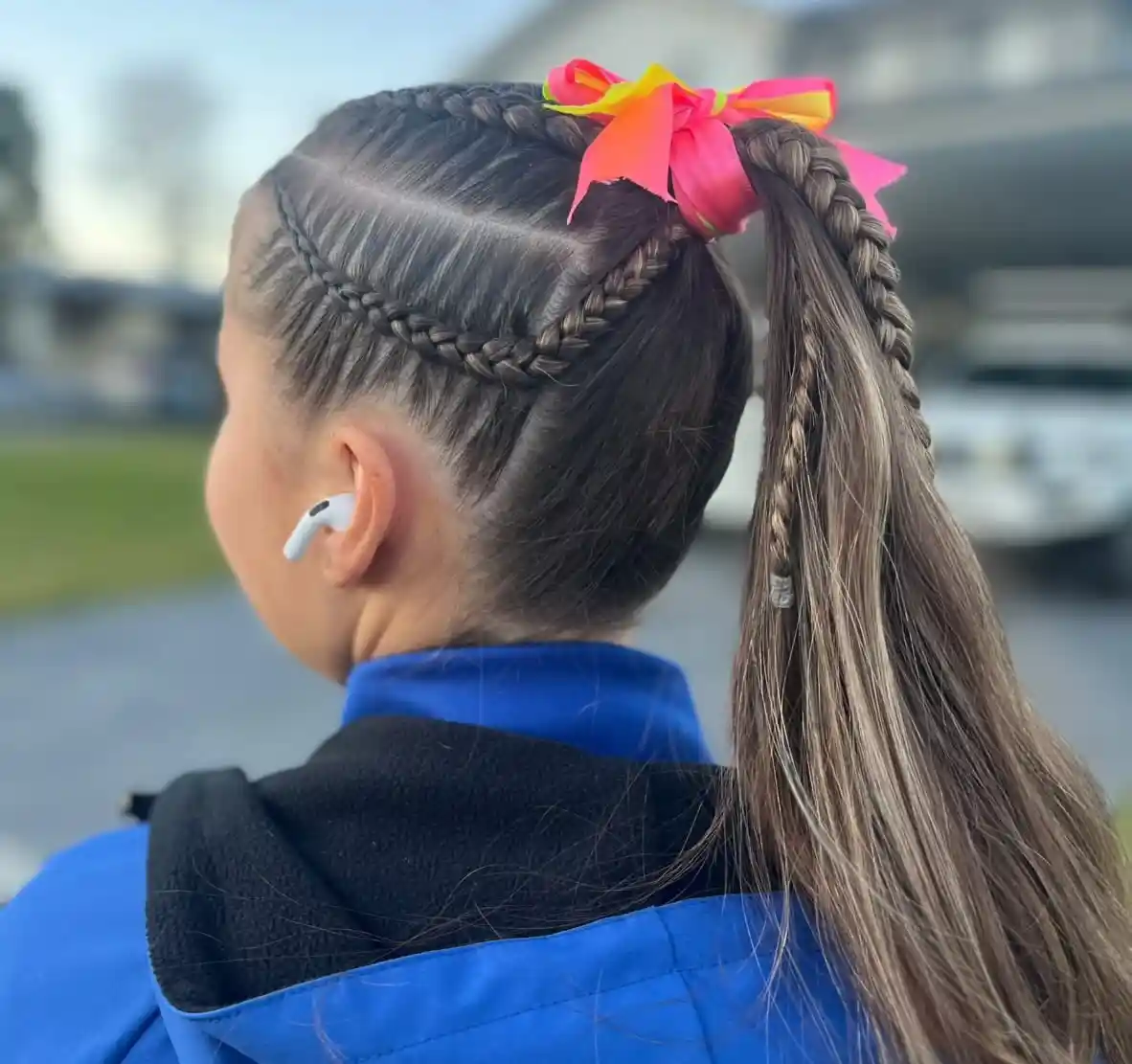 High ponytail with side braids and bright bow