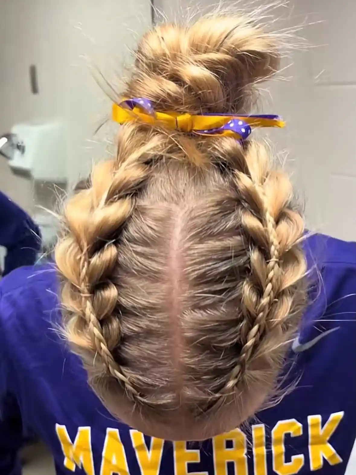 Double braids with top bun and ribbon