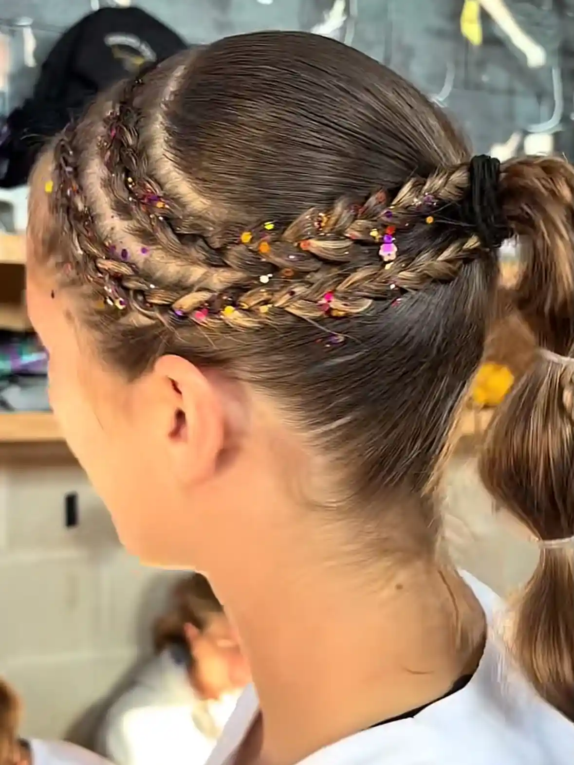 Braided ponytail with colorful confetti accents