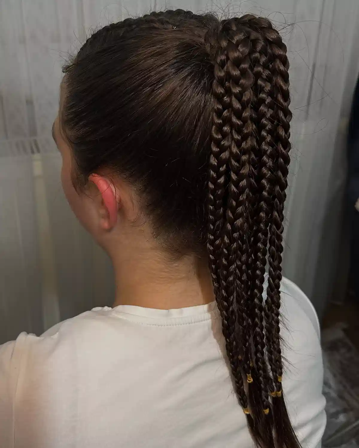 High braided ponytail with gold accents
