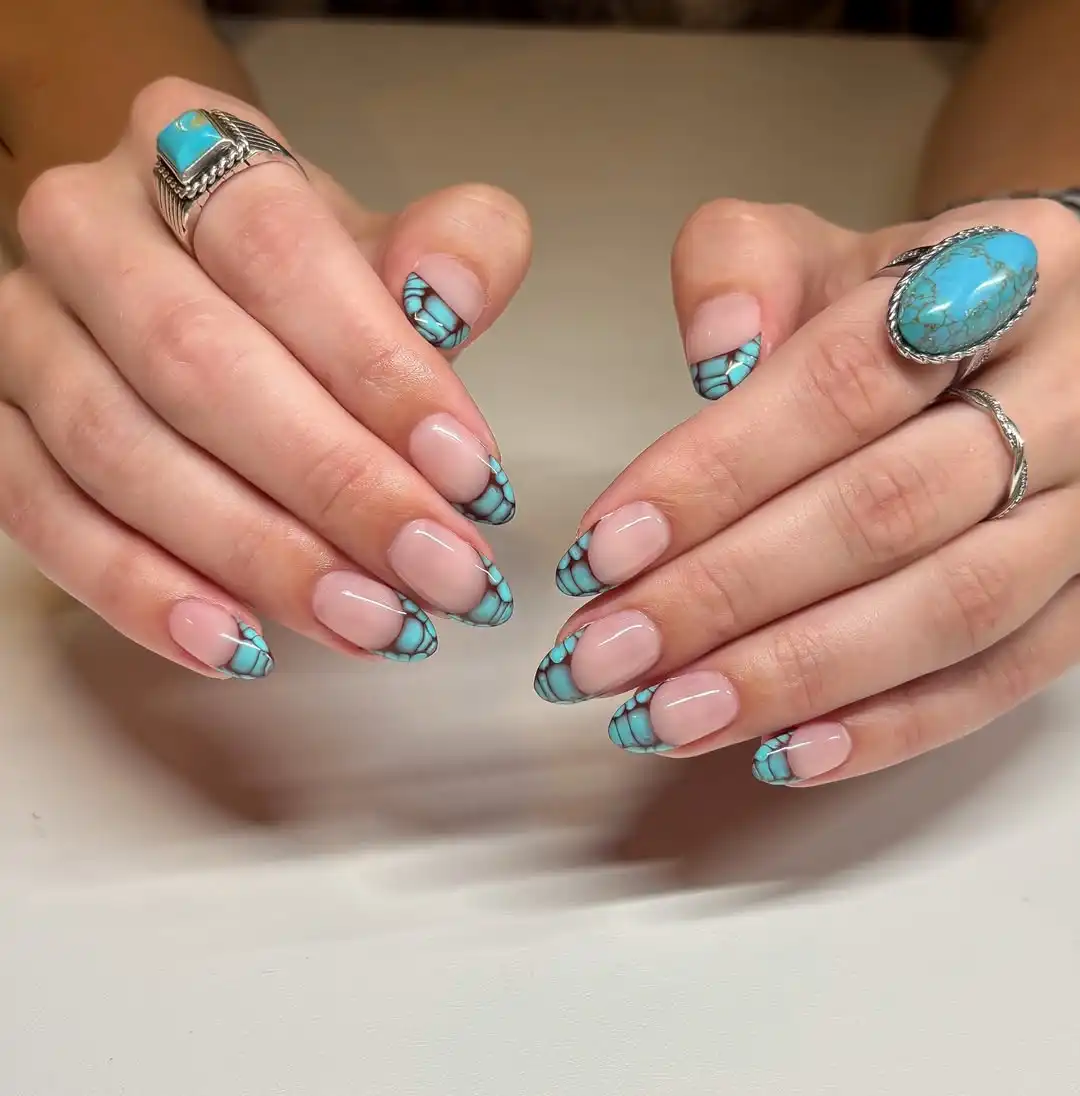 Nude nails with turquoise patterned French tips