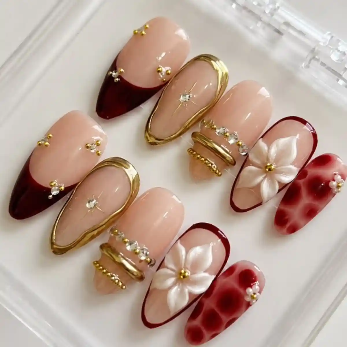 Nude and maroon set with gold frames and raised white flowers