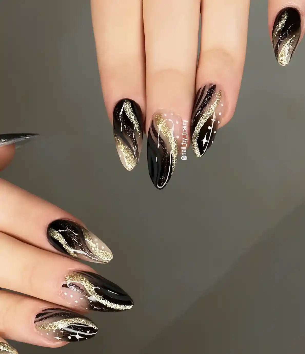 Gold glitter swooshes with white dot and sparkle accents