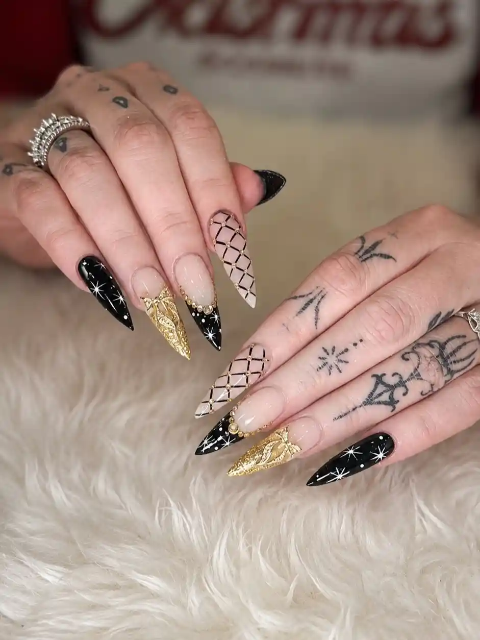 Starburst black nails with gold accents and lattice details