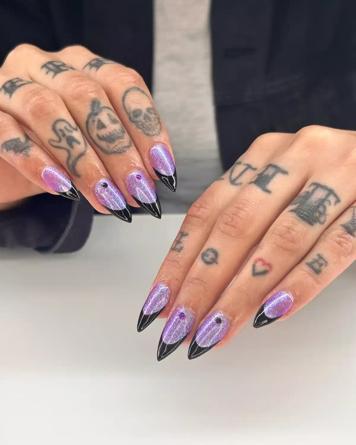 Shimmery lilac nails with black V French tips