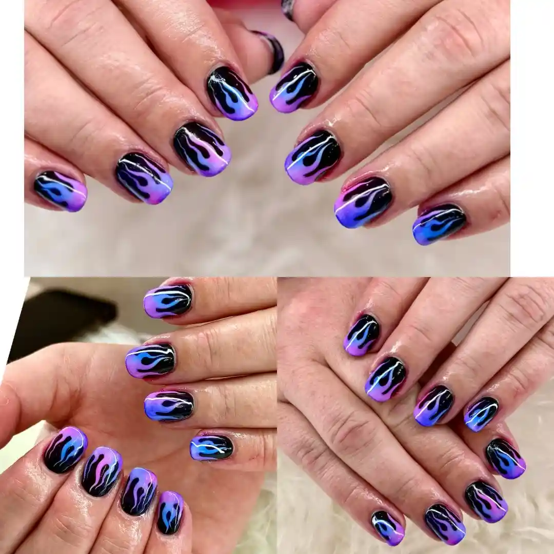 Black nails with purple-and-blue flame tips