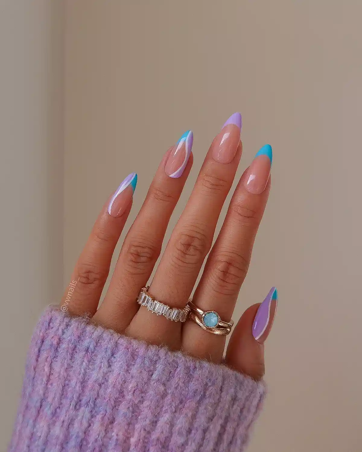 Nude almond nails with teal and lavender French tips