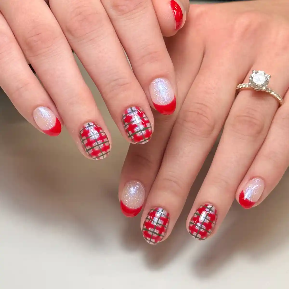 Red French tips with red-and-silver plaid accent nails