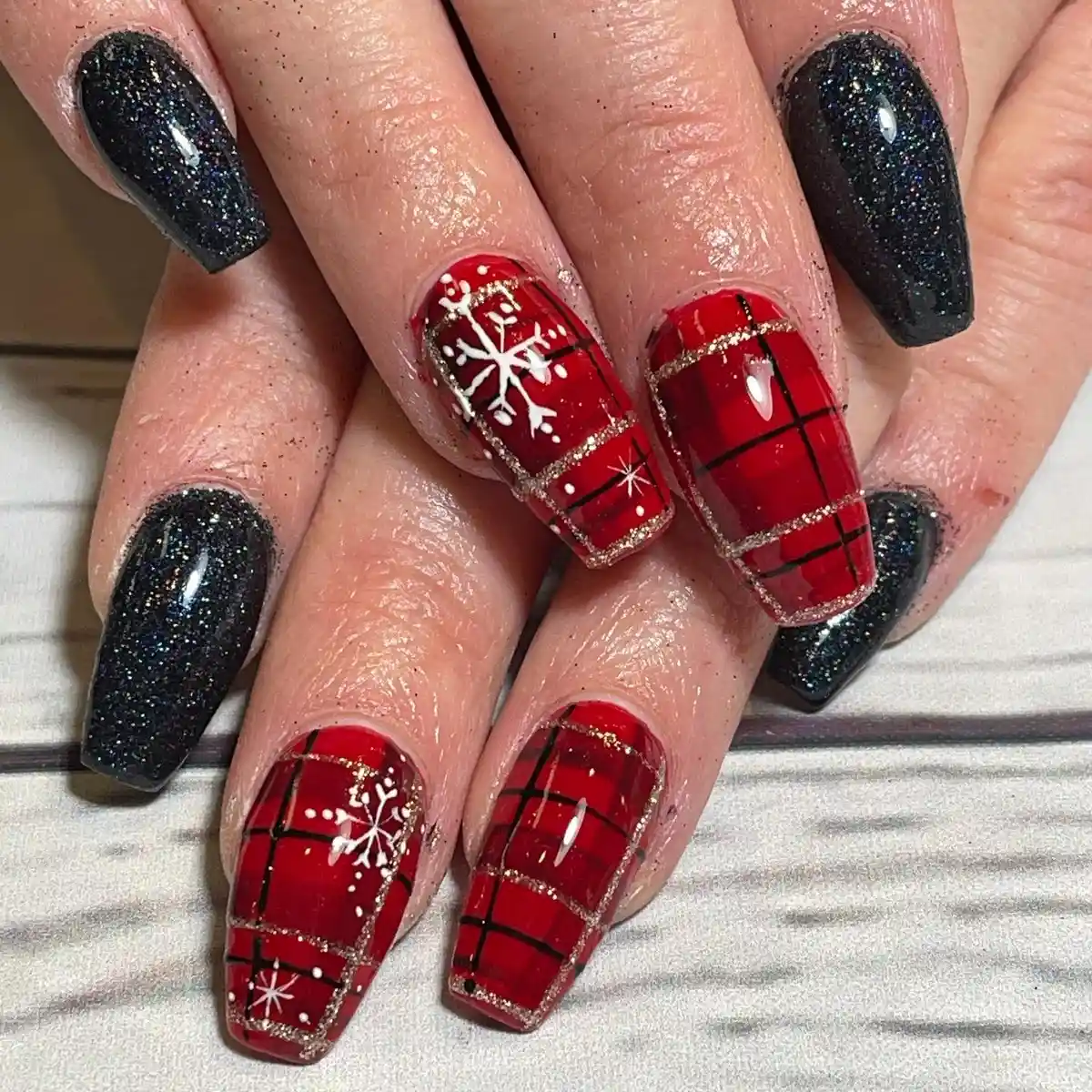 Red plaid with snowflakes paired with black glitter nails
