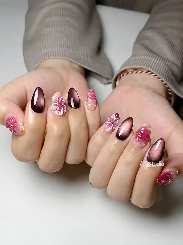 Brown chrome-like nails with pink floral accents